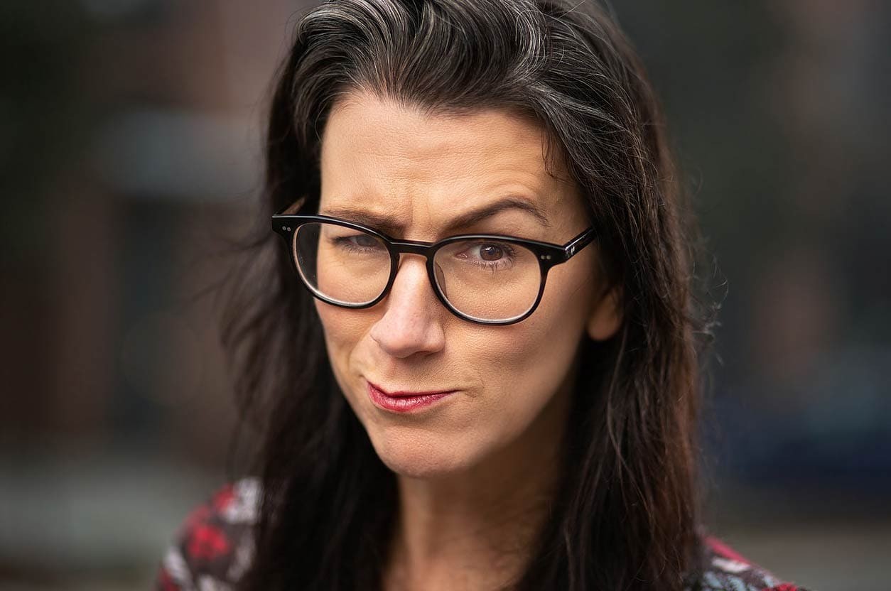 Headshot of a woman with a raised eyebrow