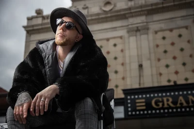 Lifestyle image of a man in front of a theater