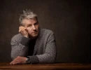 Professional Headshot of man sitting at a desk in the studio
