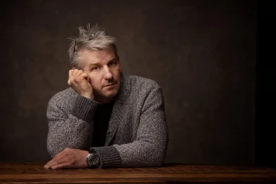 Professional Headshot of man sitting at a desk in the studio