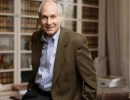Professional Headshot of business man leaning on a desk