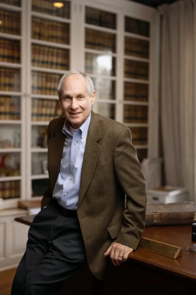 Professional Headshot of business man leaning on a desk