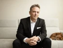Professional Headshot of man sitting on a couch 