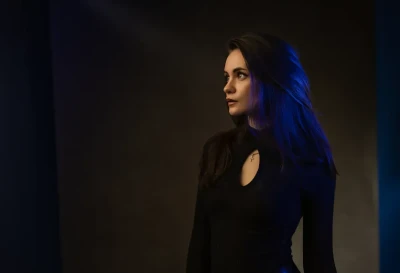 Professional Headshot of woman posing in the studio with blue lighting