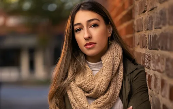 Outdoor portrait of a woman wearing a tan scarf
