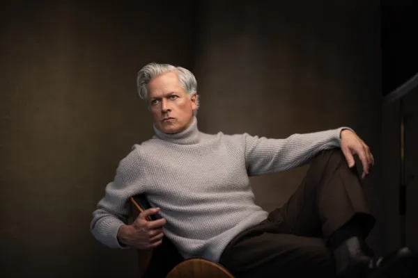 Studio portrait of an actor in a grey sweater