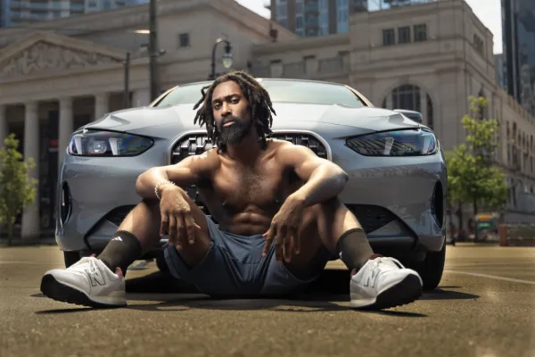 Portrait of a hip-hop artist in front of a car